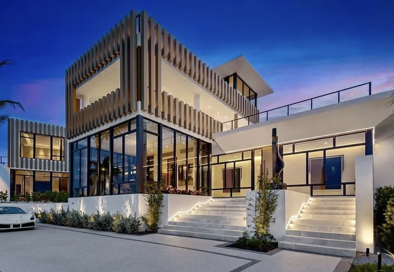 Waterfront view of the residence at sunset